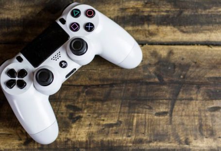 Games - White Gaming Console on Wooden Surface